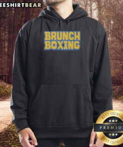 Trendy Top Brunch Boxing Hoodie displayed on a wooden table, perfect for stylish brunch outings and fitness enthusiasts.