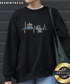 Alt Text: Cozy 'Top Colorado Rockies Autism Puzzle Heartbeat Sweatshirt' featuring a vibrant puzzle design, perfect for autism awareness.