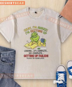 Top Grinch t-shirt design featuring 'Okay I'm Awake, I'm Getting Up' text, perfect for Christmas spirit and holiday fun.