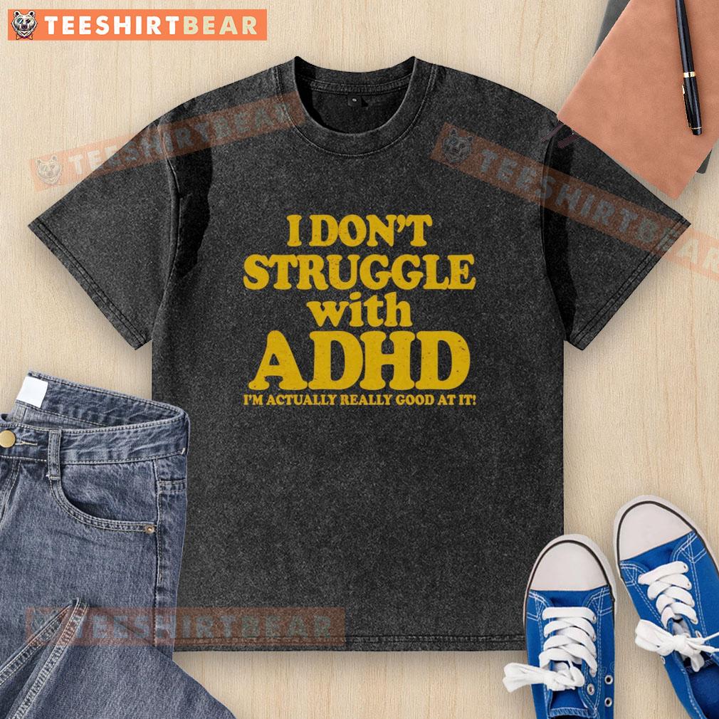 Top 'I Dont Struggle With ADHD, Im Actually Really Good At It' washed t-shirt displayed on a hanger against a neutral background.