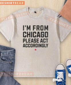 Top Im From Chicago Please Act Accordingly washed t-shirt displayed on a hanger against a neutral background.