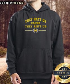 Top Michigan Wolverines Basketball hoodie with 'They Hate Us Cause They Ain't Us' slogan, perfect for fans.