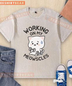 Person wearing a washed T-shirt featuring Meowscles design, showcasing a stylish and casual look.