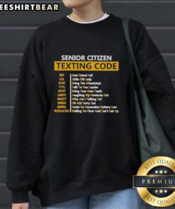 Awesome senior citizens wearing a texting code sweatshirt, showcasing humor and style for active older adults.