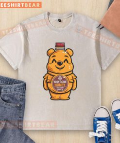 Cute bear design on a honey bottle graphic printed on a washed t-shirt, perfect for casual wear.