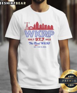 Alt Text: Retro T-shirt featuring WKRP 106.7, 97.7, and 94.5 with city skyline, celebrating The Real WKRP since May 4, 2026.