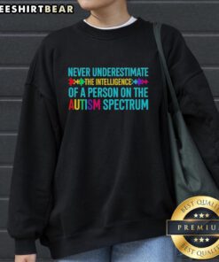 Hot 'Never Underestimate The Intelligence Of A Person On The Autism Spectrum' sweatshirt in vibrant colors, promoting awareness.