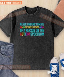 Alt Text: Person wearing a 'Never Underestimate The Intelligence Of A Person On The Autism Spectrum' washed t-shirt.
