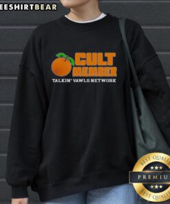 Premium Orange Cult Member Talking Vawls Network Fan Sweatshirt displayed on a mannequin against a vibrant backdrop.