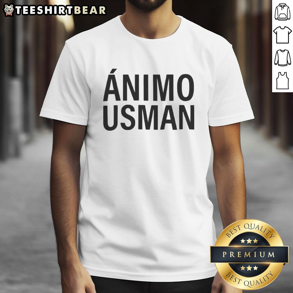Real Madrid players wearing 'Stay Strong Usman' T-shirts, showcasing support and unity in a vibrant team atmosphere.