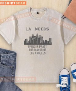Spencer Pratt in Los Angeles wearing a 'Mayor of LA' washed t-shirt against a vibrant cityscape backdrop.