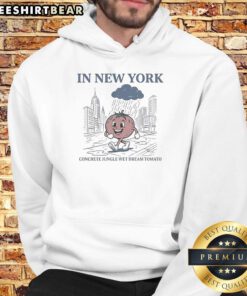 Pretty tomato walking in the rain wearing a 'Concrete Jungle Wet Dream' hoodie in New York City.