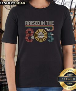Stylish 'I Was Raised In The 80s' ladies tee featuring retro graphics, perfect for 80s nostalgia fans.