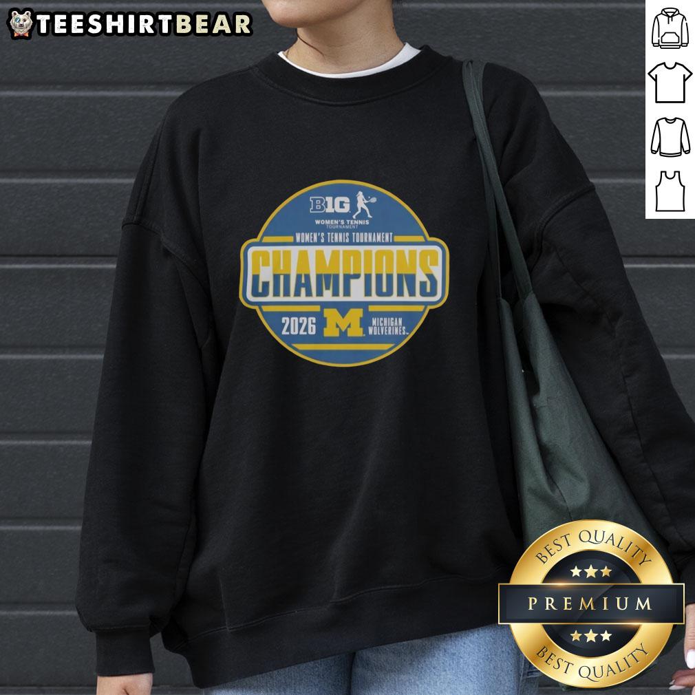 Alt Text: Michigan Wolverines 2026 Big Ten Women's Tennis Tournament champions sweatshirt in team locker room setting.