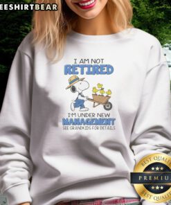 Funny Snoopy Woodstock Peanuts I Am Not Retired I'M Under New Management See Grandkids sweatshirt in charcoal gray with bold white and yellow print
