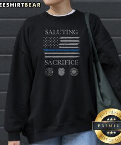Saluting Sacrifice Fire Dept Police Emergency Medical Services Sweatshirt in black, featuring bold tribute text on front