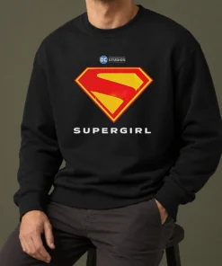 Awesome Supergirl DC Studios Logo Sweater in charcoal gray, featuring a bold graphic on the front