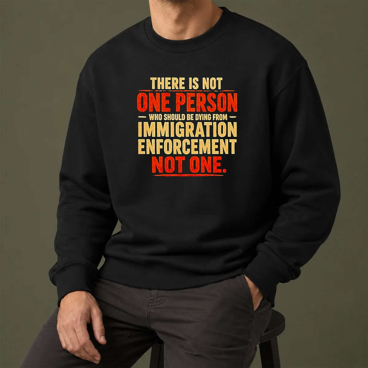 Good There Is Not One Person WHO Should Be Dying From Immigration Enforcement Sweater in black, long-sleeve crewneck made of soft cotton blend